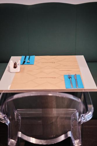 a table with a fork and knife and a napkin at Hotel Lux Santiago in Santiago de Compostela