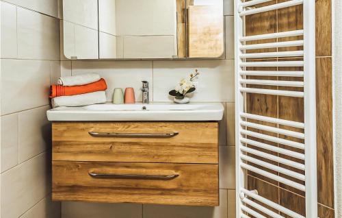 a bathroom with a sink and a mirror at Schoenes Ferienhaus Zillertal in Hart im Zillertal