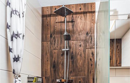 a shower with a wooden door in a bathroom at Schoenes Ferienhaus Zillertal in Hart im Zillertal