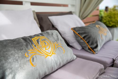 a couple of pillows sitting on a couch at Love and Dream Élményvilla in Zalakaros