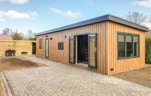 a small wooden building with a patio at 2 Bedroom Cozy Home In Heinkenszand in Heinkensand