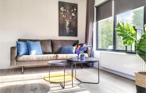 a living room with a couch and a table at 2 Bedroom Cozy Home In Heinkenszand in Heinkensand