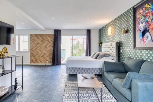 a living room with a bed and a couch at Studio 1 in Coubron