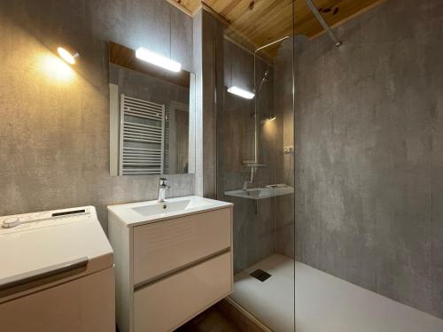 a bathroom with a sink and a mirror at Homency - Résidence les Chanses E3 in L'Alpe-d'Huez