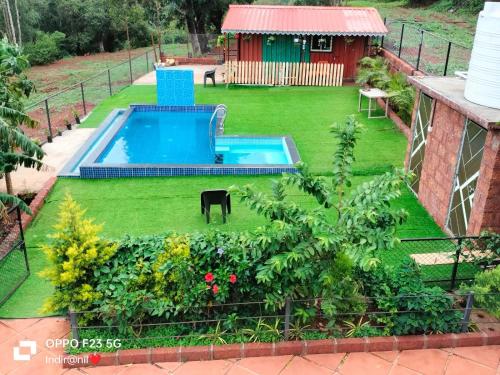 an aerial view of a yard with a swimming pool at Sweet Water Villa in Panchgani