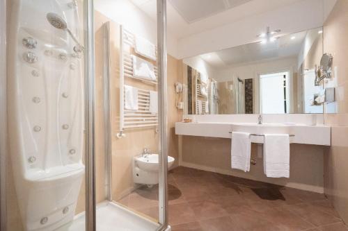 a bathroom with a sink toilet and a shower at Park Hotel Pineta Boutique Hotel in Caorle
