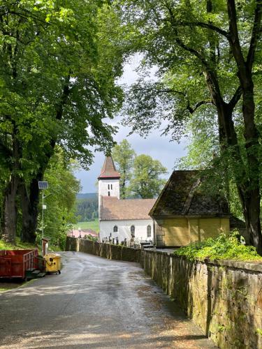 a road in front of a church and a building at Apartmán na úpatí Šumavy in Stachy