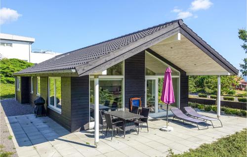 a house with a patio with a table and chairs at Stunning Home In Allinge in Allinge