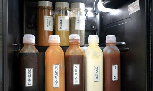 a refrigerator filled with lots of different types of sauce at Anyang ILLOWA Hotel in Anyang