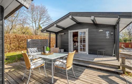a patio with a table and chairs on a deck at Nice Home In Knebel With Kitchen in Knebel