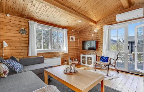 a living room with a couch and a table at Nice Home In Knebel With Kitchen in Knebel