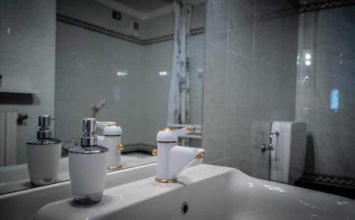 a bathroom with two soap dispensers on a sink at Seconda stella a destra in Valgrisenche