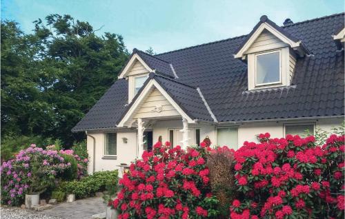 a house with red flowers in front of it at 4 Bedroom Pet Friendly Home In Brande in Brande