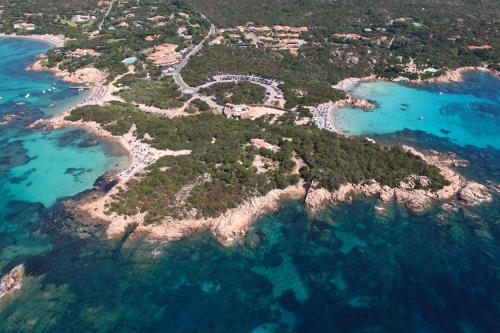a large body of water with a beach at Residenza Capriccioli in Porto Cervo