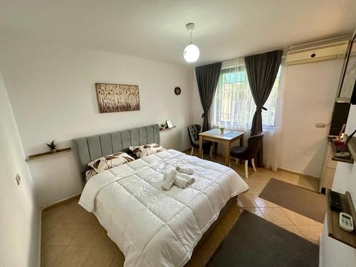 a bedroom with a bed with a teddy bear on it at Krid Tirana Studio Flat in Tirana