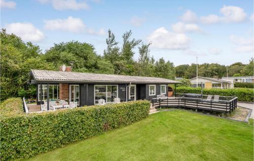a home with a garden and a house at Amazing Home In Roslev With Wifi in Roslev