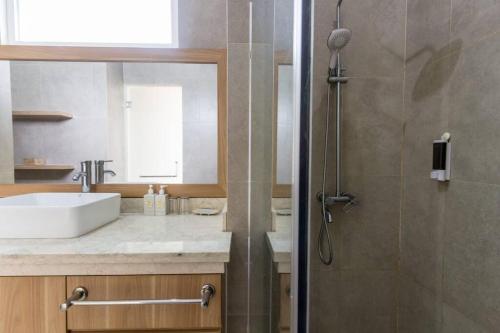a bathroom with a sink and a shower at Villa Omah Ayu Mendiro in Ngemplak