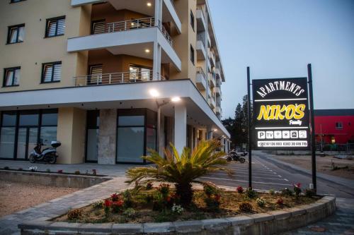 a building with a sign in front of it at Apartments NIKOS FAMILY in Ulcinj