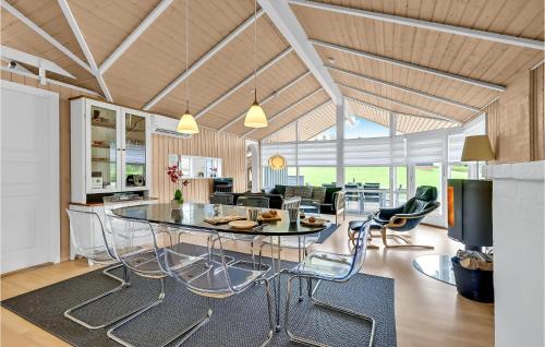 a kitchen and living room with a table and chairs at Holiday Home Skovridervænget Rudkøbing Xi in Spodsbjerg