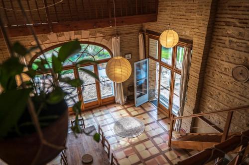 an overhead view of a room with large windows at La Maison de l'écolieu du Turc - Piscine partagée in Le Mas-dʼAgenais