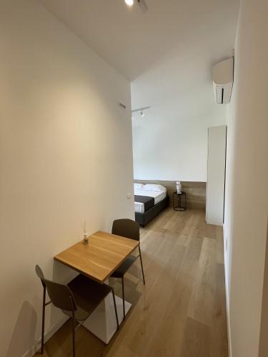 a room with a table and a bed in the background at Sirolo appartamenti in Sirolo