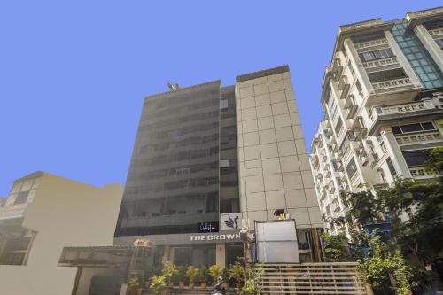 a tall building with a sign on it at Collection O THE CROWN HOTEL in Hyderabad