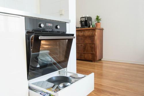 an oven with its door open in a kitchen at Studio Altbau in Weimar