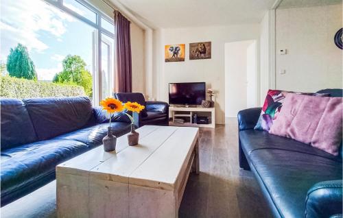 a living room with a couch and a coffee table at 4 Bedroom Cozy Home In Heinkenszand in Heinkensand