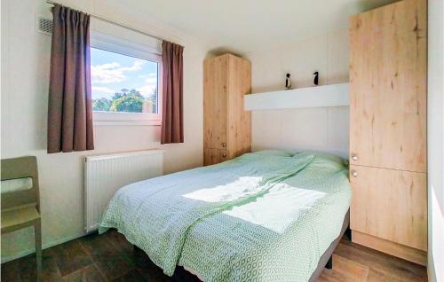 a small bedroom with a bed and a window at 4 Bedroom Cozy Home In Heinkenszand in Heinkensand