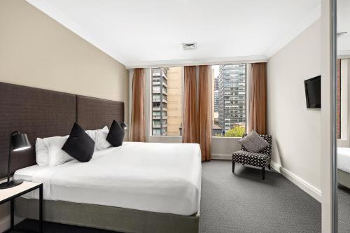 Ένα ή περισσότερα κρεβάτια σε δωμάτιο στο Melbourne City Suites