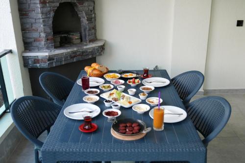 a blue table with food and drinks on it at Villa Kent Termal Otel in Gazligol