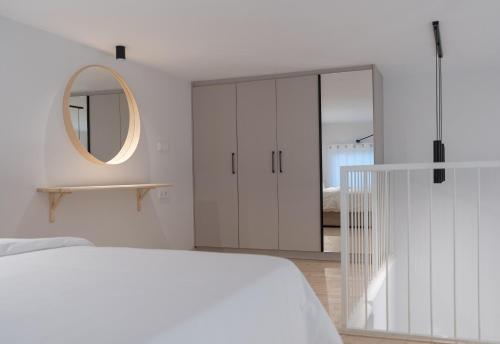 a bedroom with a white bed and a mirror at June Home in Platanes