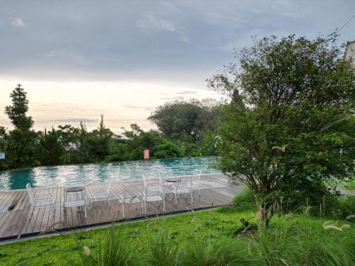 a group of chairs sitting on top of a swimming pool at Leuweung Geledegan Ecoldge in Kiarapayung 2