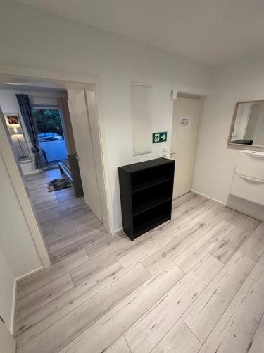 a living room with a wooden floor and a black dresser at Schöne Apartments in Königsdorf BM01 bis BM04 in Frechen