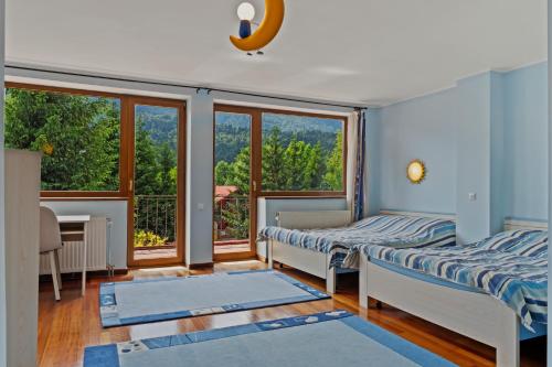 a room with two beds and a window at Wine Cellar Villa with Beautiful Garden in Sinaia - Busteni in Poiana Ţapului
