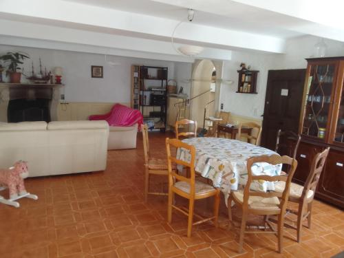 a living room with a table and chairs at Les Favouilles - Gîte & Chambres d hôtes in Dauphin