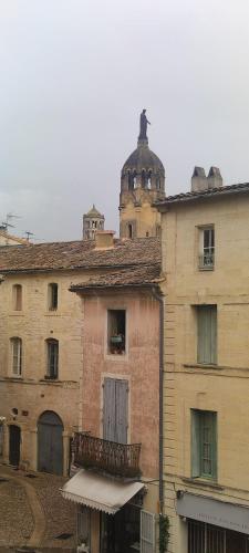 an old building with a clock tower on top of it at L'Echauguette d'Uzès by Les Demeures de Rachel in Uzès