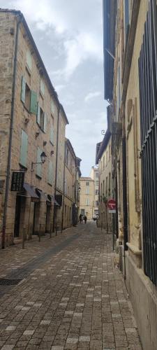 an empty street in a city with buildings at L'Echauguette d'Uzès by Les Demeures de Rachel in Uzès