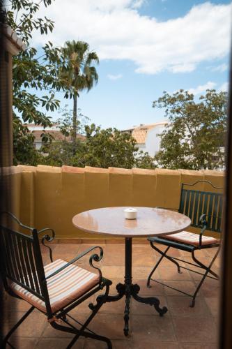 a table and two chairs sitting on a patio at Hotel Nou Romà in Denia