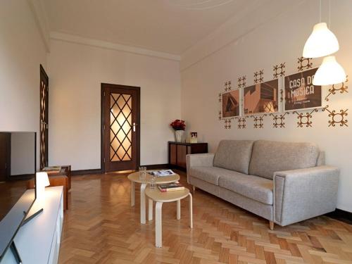 a living room with a couch and a table at Uporto House Villa in Porto