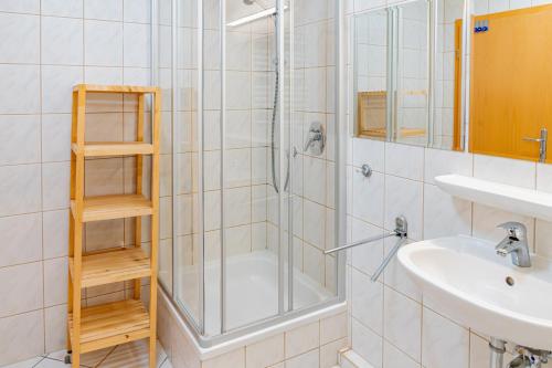 a bathroom with a shower and a sink at CBlue "Apartmenthaus Chrischanshof" in Warnemünde