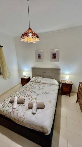 a bedroom with a bed with two pillows on it at Casa Portela in Vila Nova De Cacela