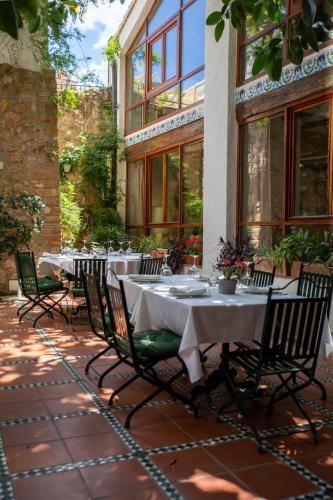 a group of tables and chairs on a patio at Hotel Nou Romà in Denia