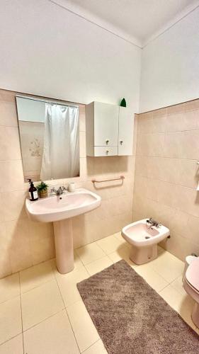 a bathroom with a sink and a toilet at Casa Portela in Vila Nova De Cacela