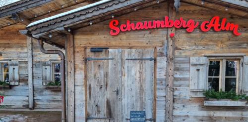 a wooden building with a sign above a door at Ferienwohnung Balduin in Sankt Wendel