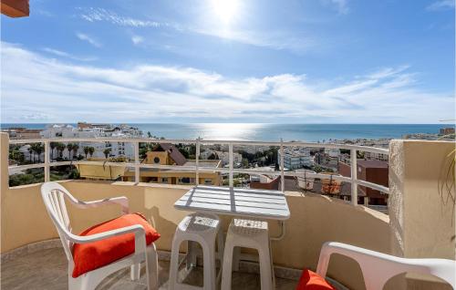 a balcony with a table and chairs and the ocean at Amazing Apartment In Torremolinos in Torremolinos