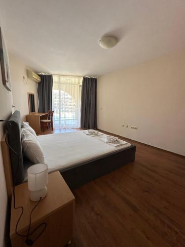 a room with a bed and a table in it at PSB Apartments in Midia Resort Aheloy in Aheloy