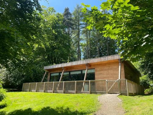 a small wooden cabin in the middle of a field at Yorkshire Dales Lodge 8 by Together Travel - 3-Bed Ensuite Retreat in Richmond