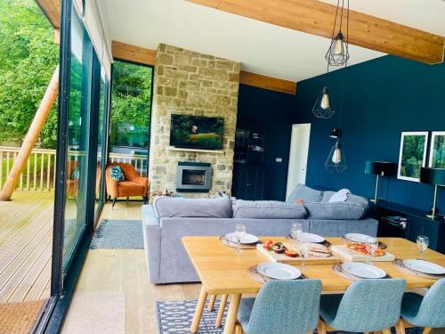 a living room with a couch and a table at Yorkshire Dales Lodge 8 by Together Travel - 3-Bed Ensuite Retreat in Richmond