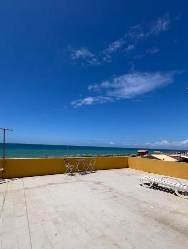 two chairs sitting on a balcony overlooking the ocean at Blife Faro Beach Hostel & Rooms in Faro
